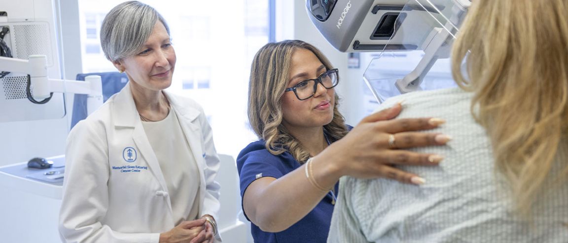 Two MSK medical practitioners assist a patient during a breast cancer screening procedure.