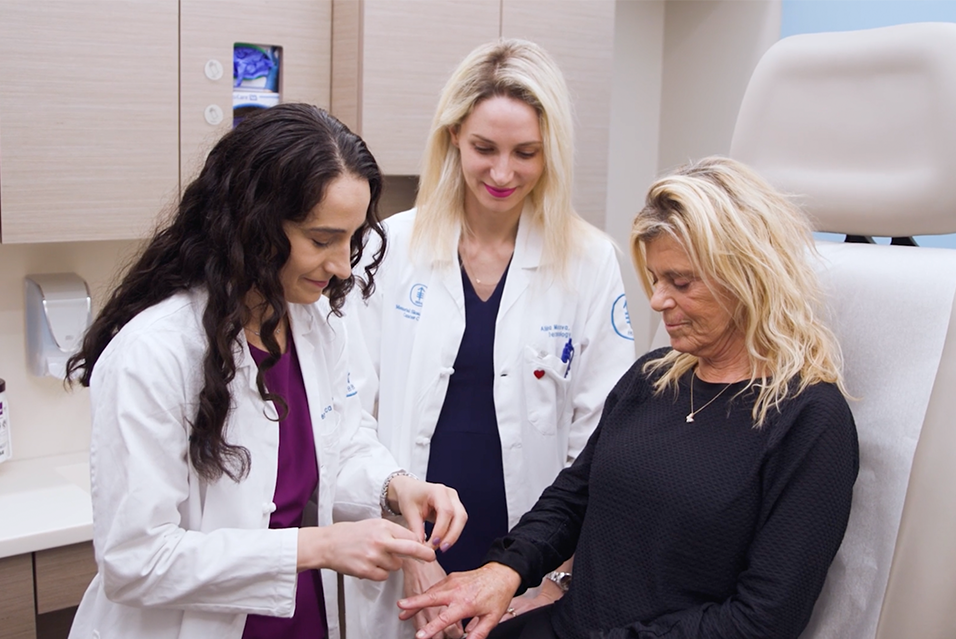 MSK’s Dr. Veronica Rotemberg and Dr. Alina Markova in clinic with a patient.
